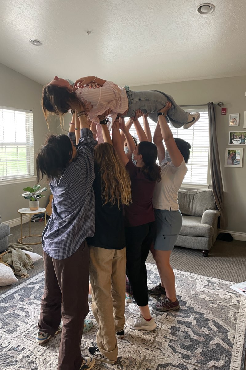 Group therapy session, girls lifting up a student, New Haven Residential Treatment Center